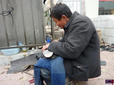 Guy fixing Bo's shoes.