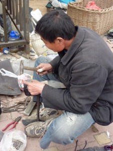 Guy fixing Bo's shoes.